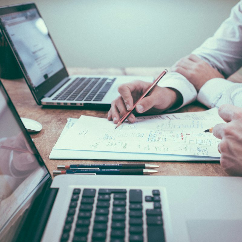 Accountant reviewing financial reports at a laptop