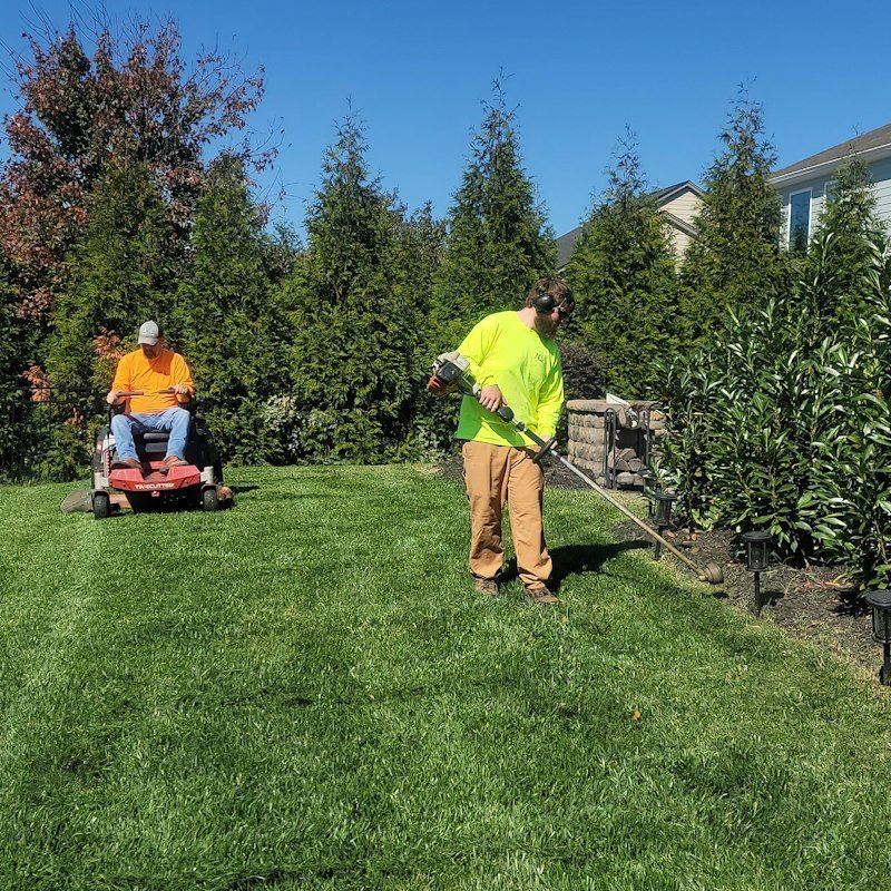 Landscaper mowing a residential lawn