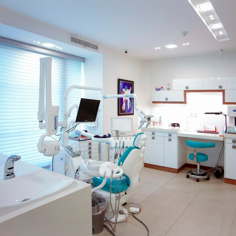 Modern dental office with a patient chair and equipment