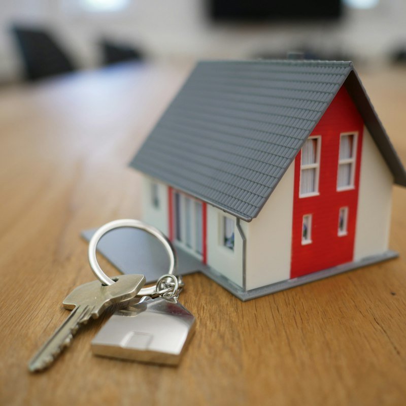 Miniature house model on a table representing real estate