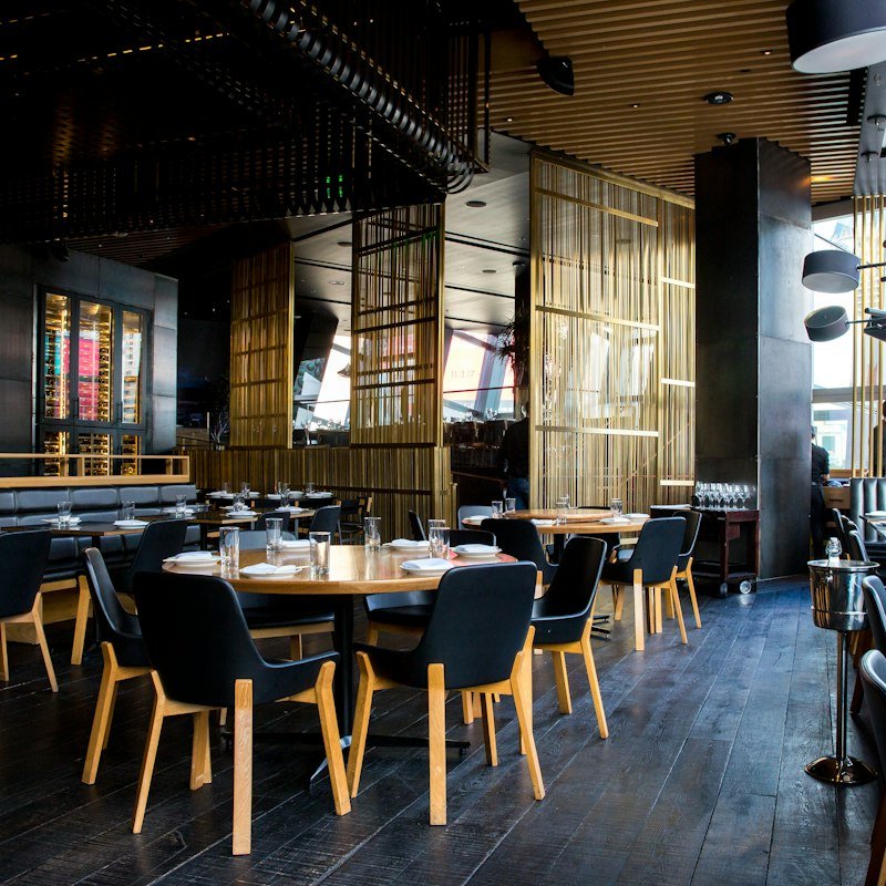 Warm, inviting restaurant dining room with tables set for guests